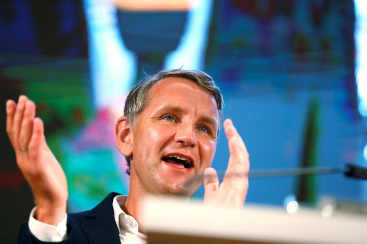 Bjoern Hoecke reacts on stage after evidence emerges of the AfD's surge