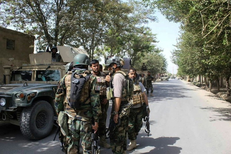 Afghan soldiers gather at a street in Kunduz, where US air power helped them beat back a brazen Taliban assault, but with the loss of 20 troops and five civilians, officials said