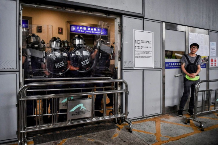 Riot police block an entrance at Hong Kong International Airport on September 1 to stop protesters from entering the terminal building