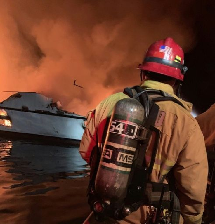 In this photo released by the Ventura County Fire Department, firefighters attempt to extinguish a fire on a boat off the coast of Santa Cruz Island, California