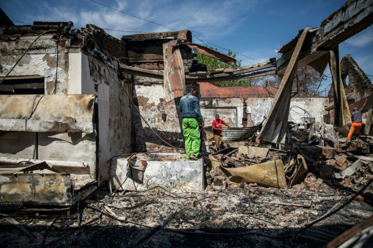 Aftermath: People rummage through looted foreign-owned shops in Malvern, a Johannesburg suburb