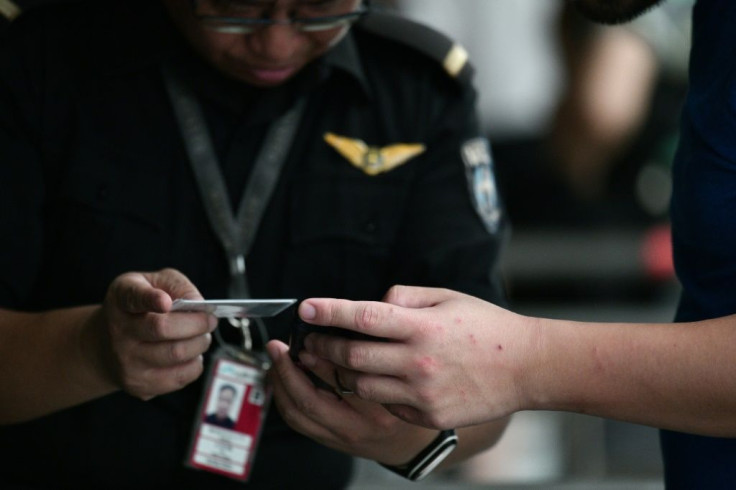 Security staff were carefully checking people's documents at the airport