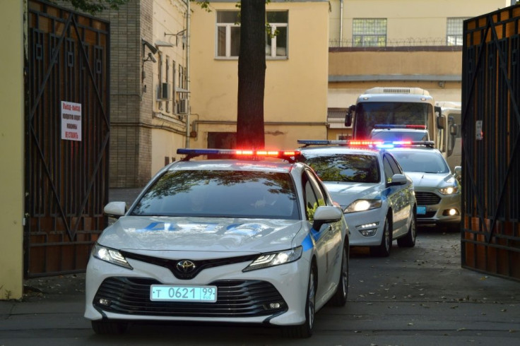 A police convoy escorts two buses with tinted windows from the high-security prison of Lefortovo in Moscow as a long-awaited exchange of prisoners between Moscow and Kiev gets underway