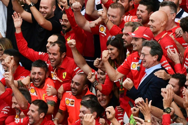 Charles Leclerc (2R) and Ferrari CEO Louis C. Camilleri (R) celebrate with team members after winning the Italian GP