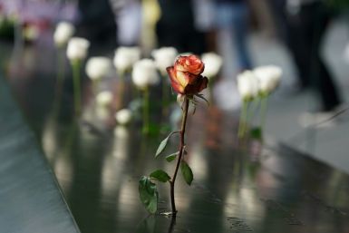 People leave flowers during the September 11 Commemoration Ceremony at the 9/11 Memorial at the World Trade Center on September 11, 2019,in New York.