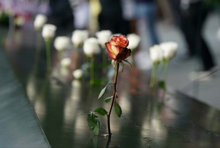 People leave flowers during the September 11 Commemoration Ceremony at the 9/11 Memorial at the World Trade Center on September 11, 2019,in New York.