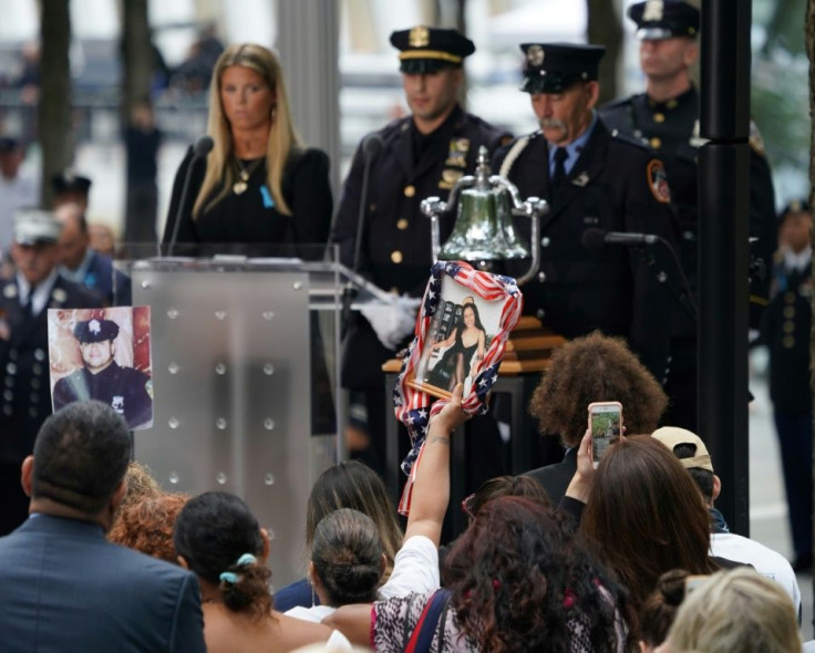 A relative holds the portrait of a victim during the September 11 Commemoration Ceremony at the 9/11 Memorial at the World Trade Center in New York