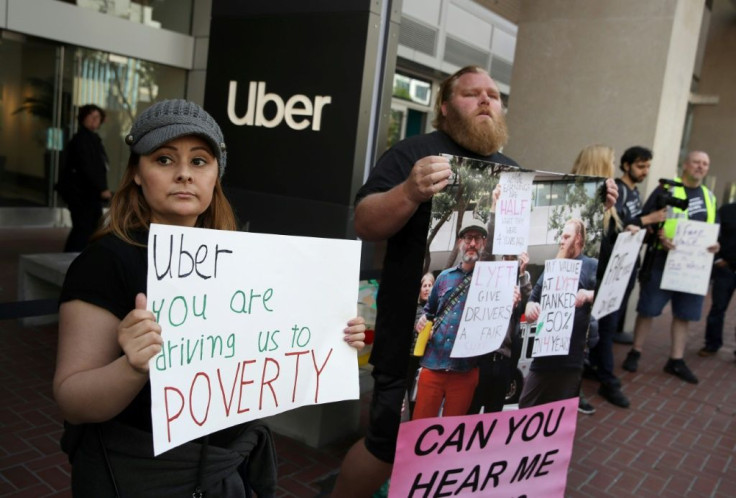 California lawmakers approved a measure to require rideshare firms to treat drivers as employees, responding to protests, such as this one seen in May outside Uber's headquarters