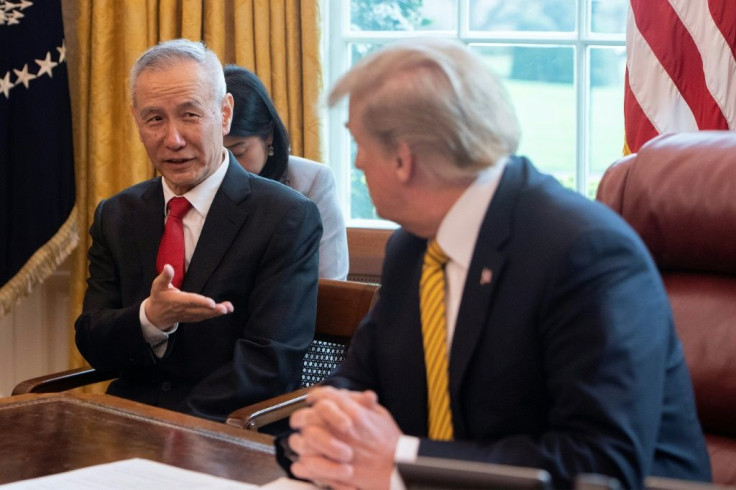 China's Vice Premier Liu He (L) speaks with US President Donald Trump during a trade meeting in the Oval Office at the White House in Washington in April 2019