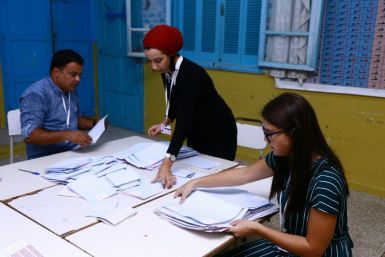 Tunisian volunteers count ballots at a polling station in Sousse, south of the capital Tunis