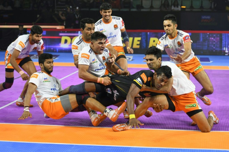 Siddharth Desai (centre) is grabbed by Puneri Paltan players in a Pro Kabaddi League match at the Thyagaraj Sports Complex in New Delhi