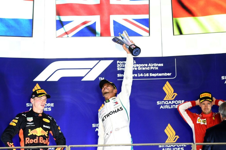 Lewis Hamilton celebrates his Singapore Grand Prix victory on the podium a year ago with second-placed Max Verstappen (left) and third-placed Sebastian Vettel