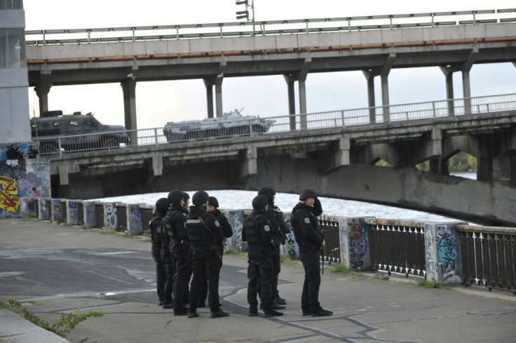 A large number of police cars and armed personnel carriers were at the scene, while special forces and snipers guarded the bridge after the man used his vehicle to block the bridge across the Dnipro river