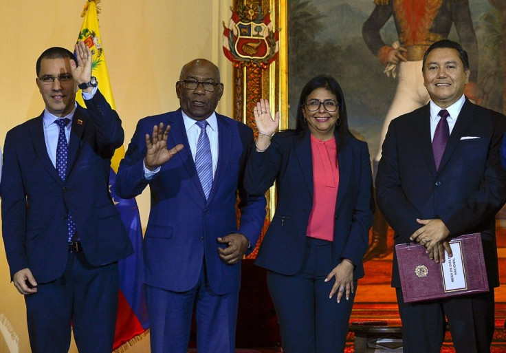Venezuelan Foreign Minister Jorge Arreaza, Education Minister Aristobulo Isturiz, Vice President Delcy Rodriguez and opposition member Javier Bertucci pose after signing a dialogue agreement between the government and the opposition in Caracas