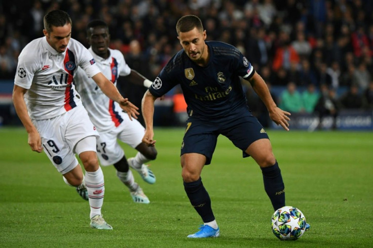 Eden Hazard (R) holds off PSG's Pablo Sarabia - the Belgian made his first start for Real Madrid in Wednesday's game