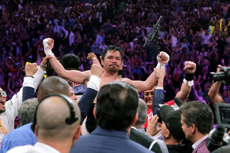 Filipino boxer Manny Pacquiao (C) celebrates after beating US boxer Keith Thurman in a WBA super world welterweight title fight in Las Vegas in July 2019