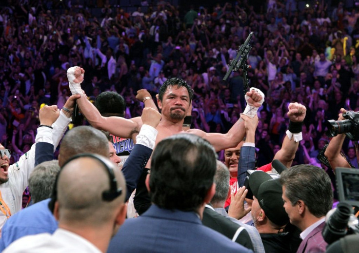 Filipino boxer Manny Pacquiao (C) celebrates after beating US boxer Keith Thurman in a WBA super world welterweight title fight in Las Vegas in July 2019