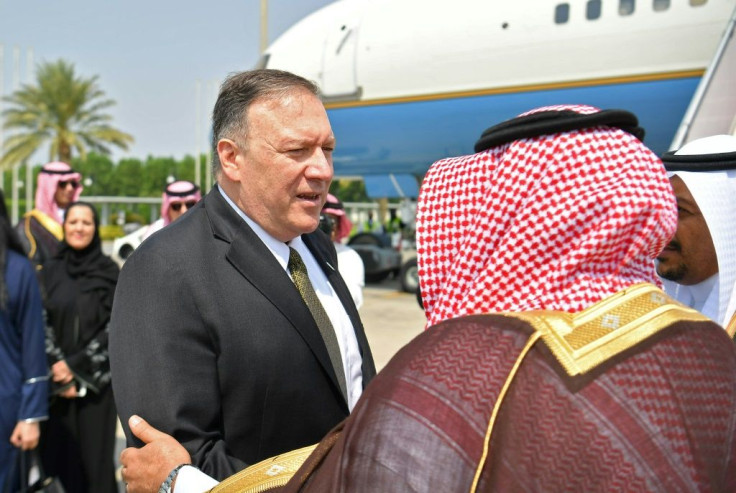 US Secretary of State Mike Pompeo speaks with a Saudi official before boarding his flight from Jeddah, Saudi Arabia to the UAE