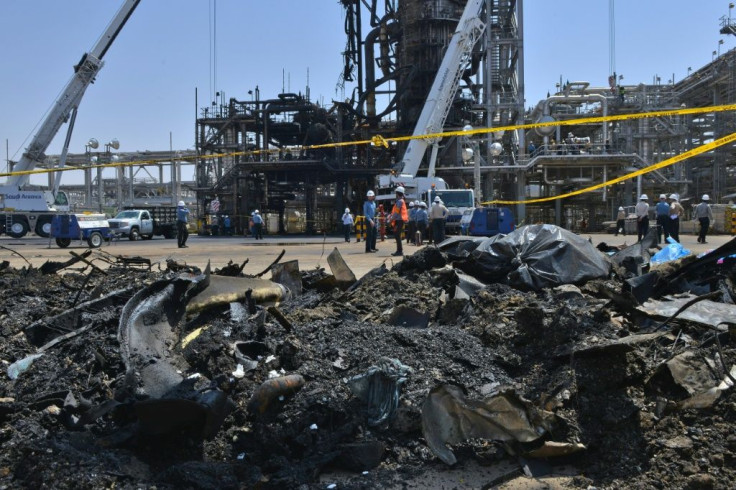 Saudi engineers use cranes to remove the mangled wreckage of production machinery at the Khurais oilfield, one of two facilities hit by dramatic drone and missile strikes last Saturday
