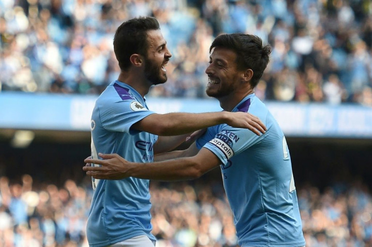 Manchester City's Bernardo Silva (L) celebrates with David Silva during their thrashing of Watford