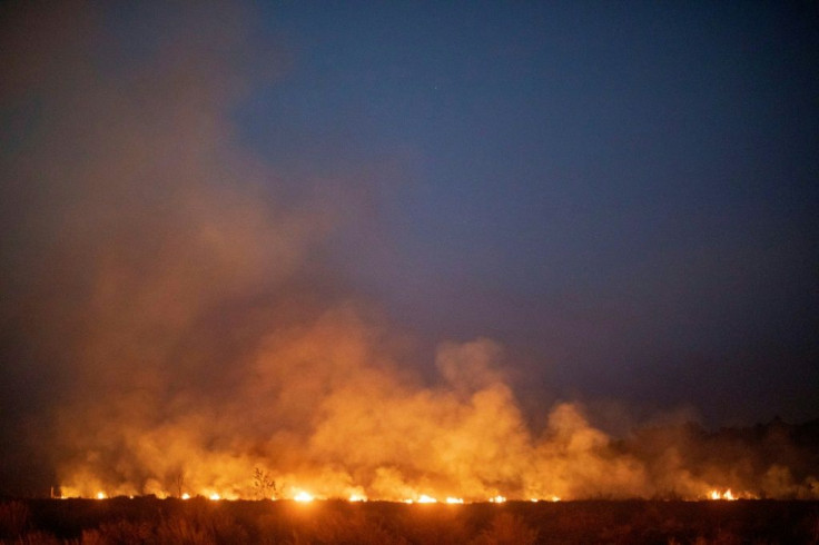 A forest wildfire spreads onto a farm in the municipality of Nova Santa Helena, in Brazil's Mato Grosso state, in the southern Amazon basin region