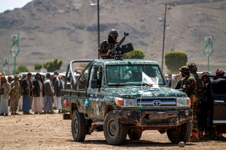 A fighter loyal to Yemen's Huthi rebels mans a machine gun turret during a tribal meeting in the Huthi-held capital Sanaa on September 21