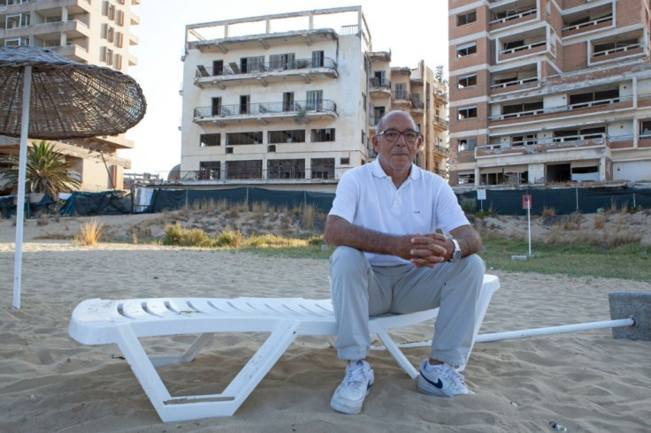 Pavlos Iacovou sits near the ghost town of Varosha, fenced off by occupying Turkish soldiers in 1974