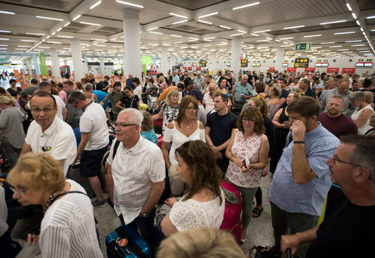 Passengers of British travel group Thomas Cook queue at Son Sant Joan airport in Palma de Majorca, Spain