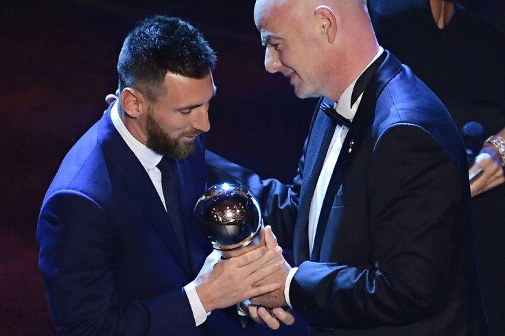 Argentina and Barcelona forward Lionel Messi (L) is presented with the men's player of year award by FIFA President Gianni Infantino.