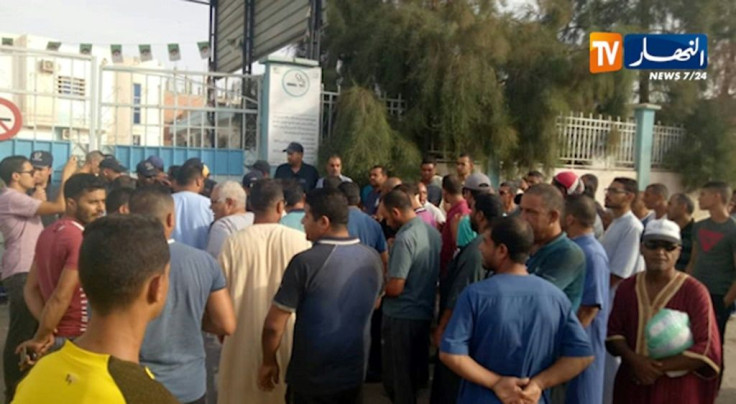 Fearful family members wait at the gates of Oued Souf maternity hospital in eastern Algeria for news of the fire which broke out before dawn killing eight babies, acording to the emergency services