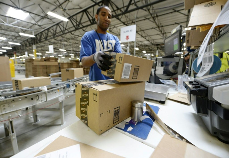 Waning consumer confidence could hit retail sales, a mainstay of the US economy. Employee Lamar Roby prepares shipping orders at Amazon's San Bernardino Fulfillment Center