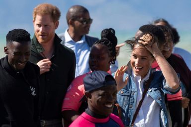 Wind and smiles: Prince Harry and his wife Meghan meet members of Waves for Change. The group uses surfing to help young people trapped in Cape Town's slums get a different perspective on life