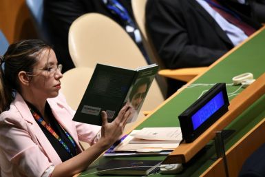 A Venezuelan delegate holds up a book referring to South American independence hero Simon Bolivar while US President Donald Trump addresses the UN General Assembly