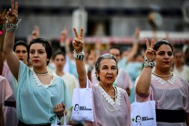 Women dressed like iconic former first lady Eva Peron march as part of protests against government economic policies