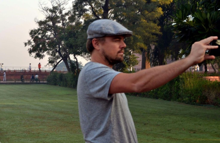 Hollywood star Leonardo DiCaprio takes a photograph in the gardens of the Taj Mahal during a visit to India in 2015