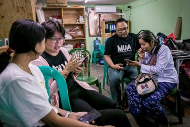 Volunteers in Yangon help phone users switch from the old Zawgi font to unicode