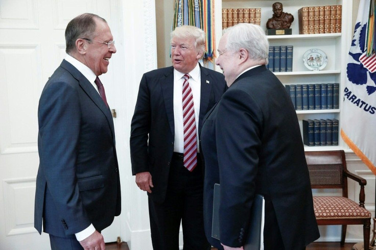 US President Donald Trump (C) speaks with Russian Foreign Minister Sergei Lavrov (L) and Russian Ambassador to the US Sergei Kislyak during their meeting at the White House in May 2017, in a photo made available by the Russian Foreign Ministry