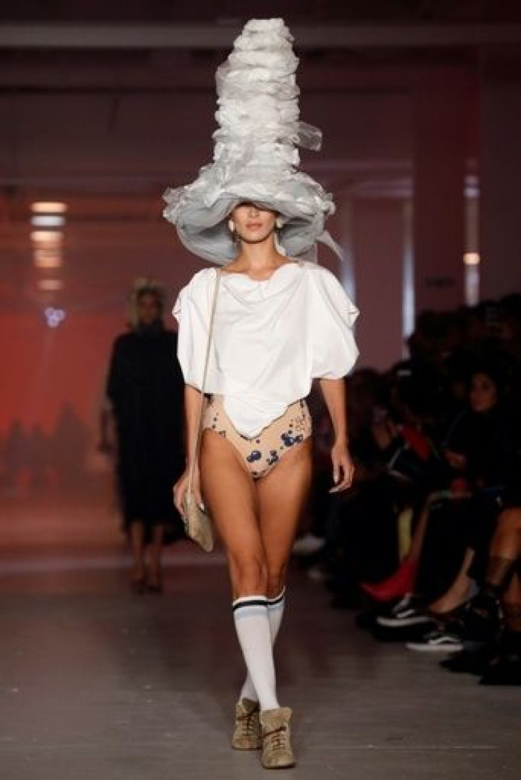 US supermodel Bella Hadid wears a outfit matching streetwear socks with an 18th-century hat and shoes at Andreas Kronthaler and Vivienne Westwood's Paris fashion show