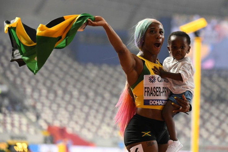Jamaica's Shelly-Ann Fraser-Pryce celebrates after winning the Women's 100m fina