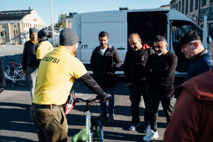 First things first -- before they head off for a spin, a group of immigrants learn how to apply the brakes