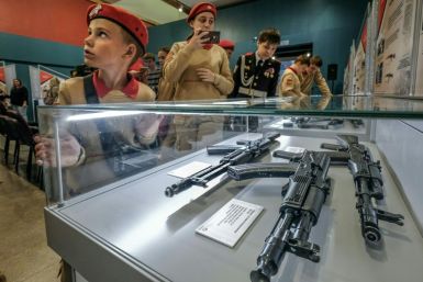 Members of Russia's Young Army patriotic movement get a close-up look at Russia's iconic Kalashnikov at a Moscow exhibition dedicated to their inventor