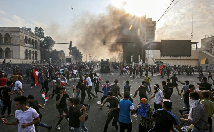 Protesters clash with an Iraqi riot police during a demonstration against state corruption and poor services in Baghdad