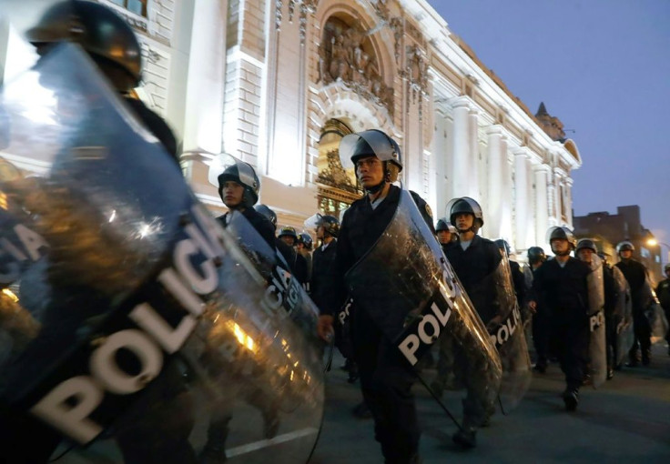 Riot police move into position around the Congress building in Lima after President Martin Vizcarra announced he was dissolving the opposition-dominated legislature