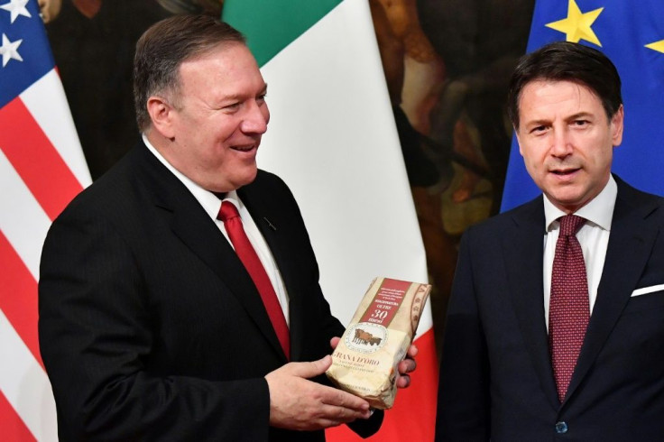 Mike Pompeo (L) smiled when he was offered the cheese