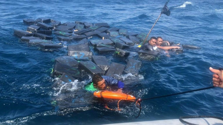 A photo released by the Colombian Navy on October 1, 2019 shows the rescue of three men floating on bales of cocaine off the Pacific coast