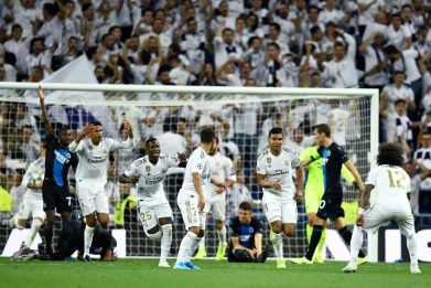 Real Madrid players celebrate after Casemiro scored to salvage a 2-2 draw against Club Brugge