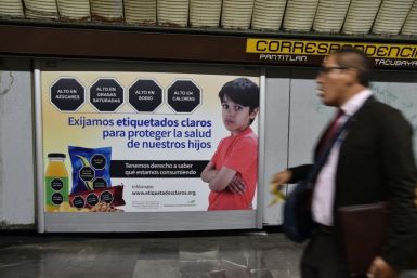 "We demand clear labeling to protect the health of our children," reads the sign in the Mexico City subway, which shows sample junk food warnings of black hexagons with white lettering