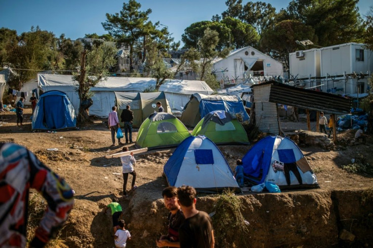 In addition to poor hygiene and frequent outbreaks of violence, many of the residents sleep in tents and complain of having to queue for hours to obtain food, take a shower or use a toilet