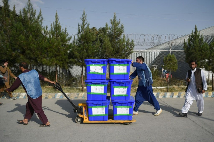 Independent Election Commission (IEC) workers in Afghanistan move ballot boxes that will go to a counting centre in Kabul, after the country's presidential election