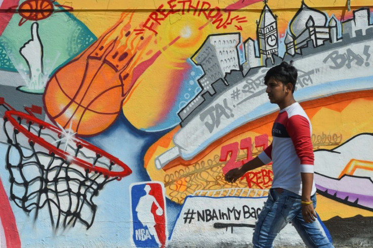 A man walks past an NBA themed mural in Mumbai ahead of the American basketball organisation's first ever games in India